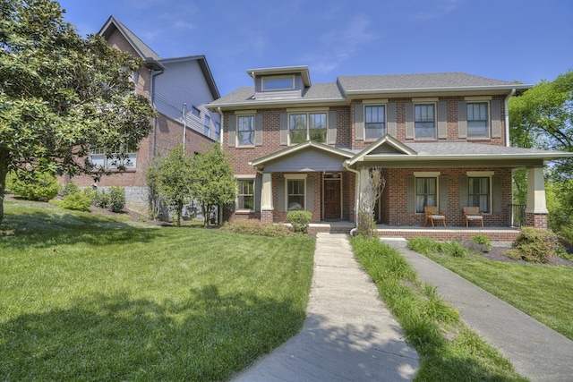 view of front of house featuring a front lawn and covered porch