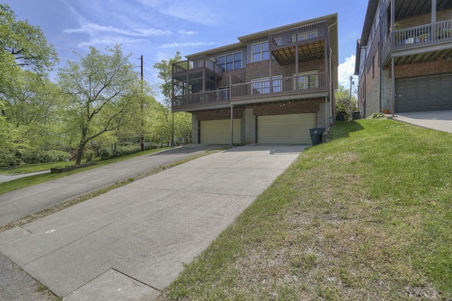 view of front property featuring a balcony, a garage, and a front lawn