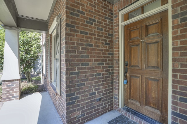 view of exterior entry featuring a porch