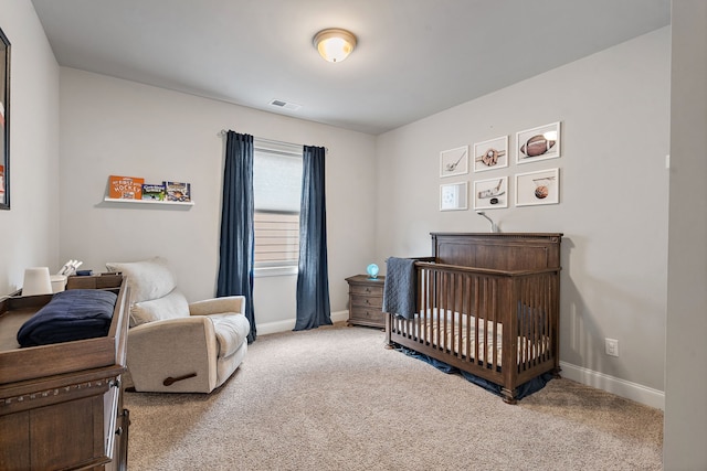 carpeted bedroom with a nursery area