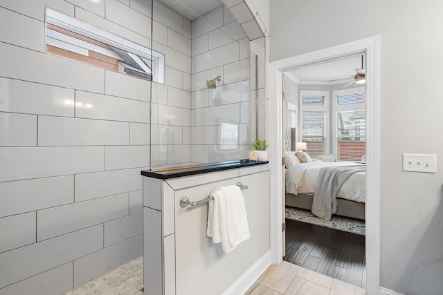 bathroom featuring walk in shower, wood-type flooring, crown molding, and ceiling fan