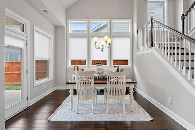 dining area featuring an inviting chandelier, plenty of natural light, dark hardwood / wood-style flooring, and high vaulted ceiling