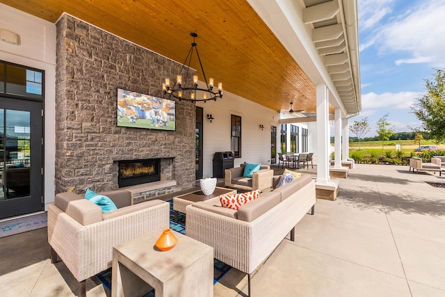 exterior space featuring an outdoor living space with a fireplace and ceiling fan