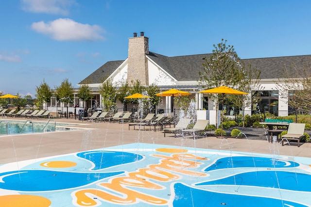 view of property's community featuring a swimming pool and a patio