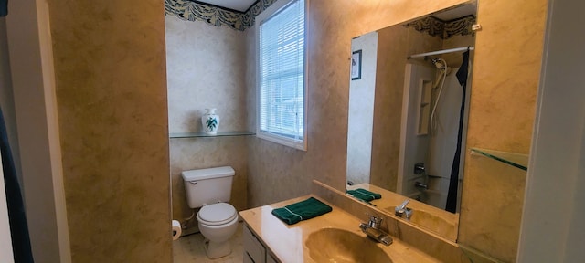 bathroom with vanity, a shower, and toilet