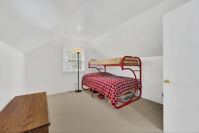 bedroom featuring vaulted ceiling and carpet floors