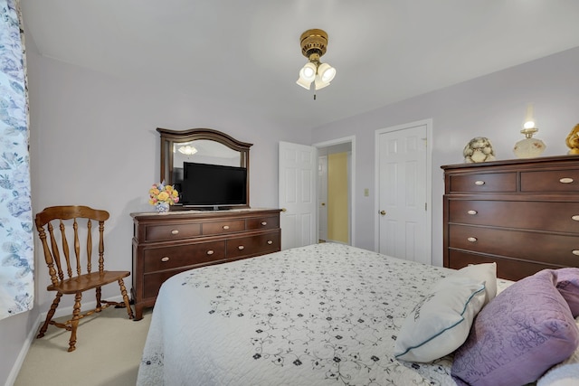 bedroom featuring light carpet and ceiling fan