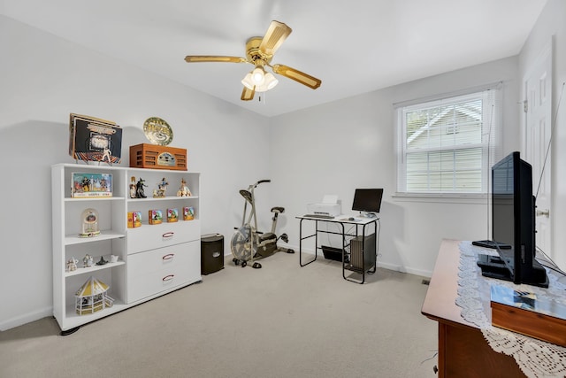 carpeted home office with ceiling fan