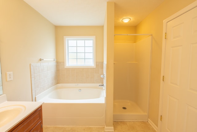 bathroom with independent shower and bath, vanity, tile patterned flooring, and a textured ceiling