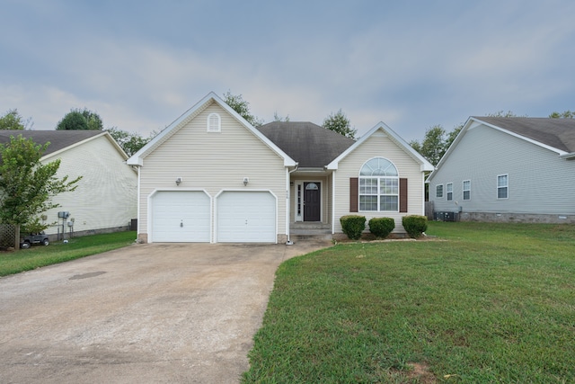 view of front of home with a front yard and a garage