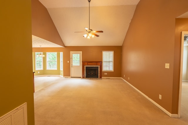 unfurnished living room featuring ceiling fan, carpet, and high vaulted ceiling