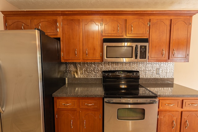 kitchen with appliances with stainless steel finishes and tasteful backsplash