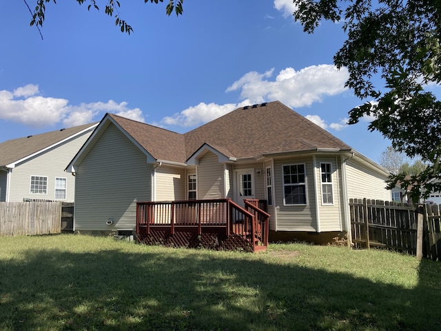 back of house featuring a wooden deck and a yard