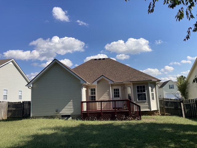 back of property featuring a deck and a yard