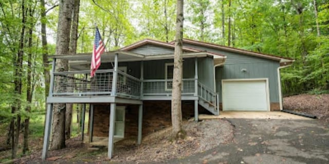 view of front of home featuring covered porch and a garage