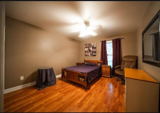 bedroom with pool table, wood-type flooring, and ceiling fan