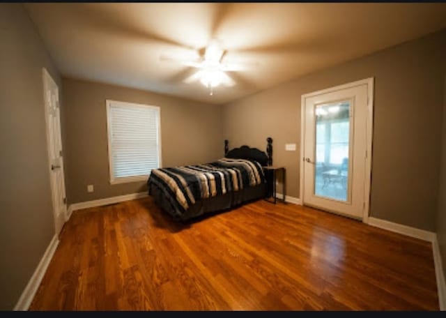 bedroom featuring wood-type flooring and ceiling fan