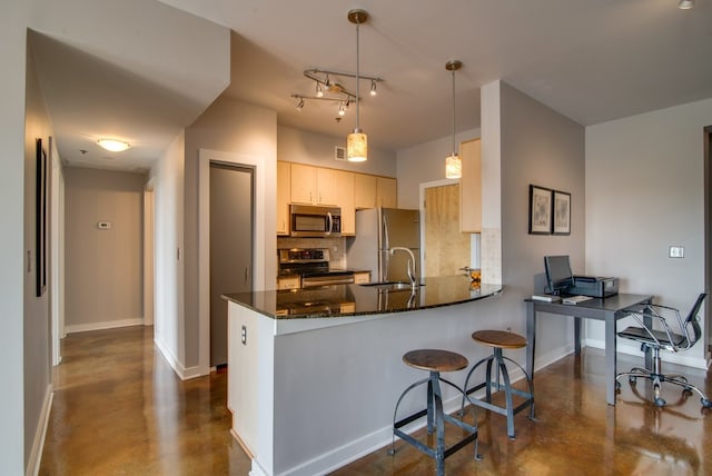 kitchen featuring hanging light fixtures, kitchen peninsula, backsplash, stainless steel appliances, and dark stone countertops