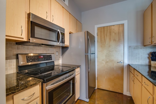 kitchen with stainless steel appliances, dark stone countertops, light brown cabinets, and tasteful backsplash