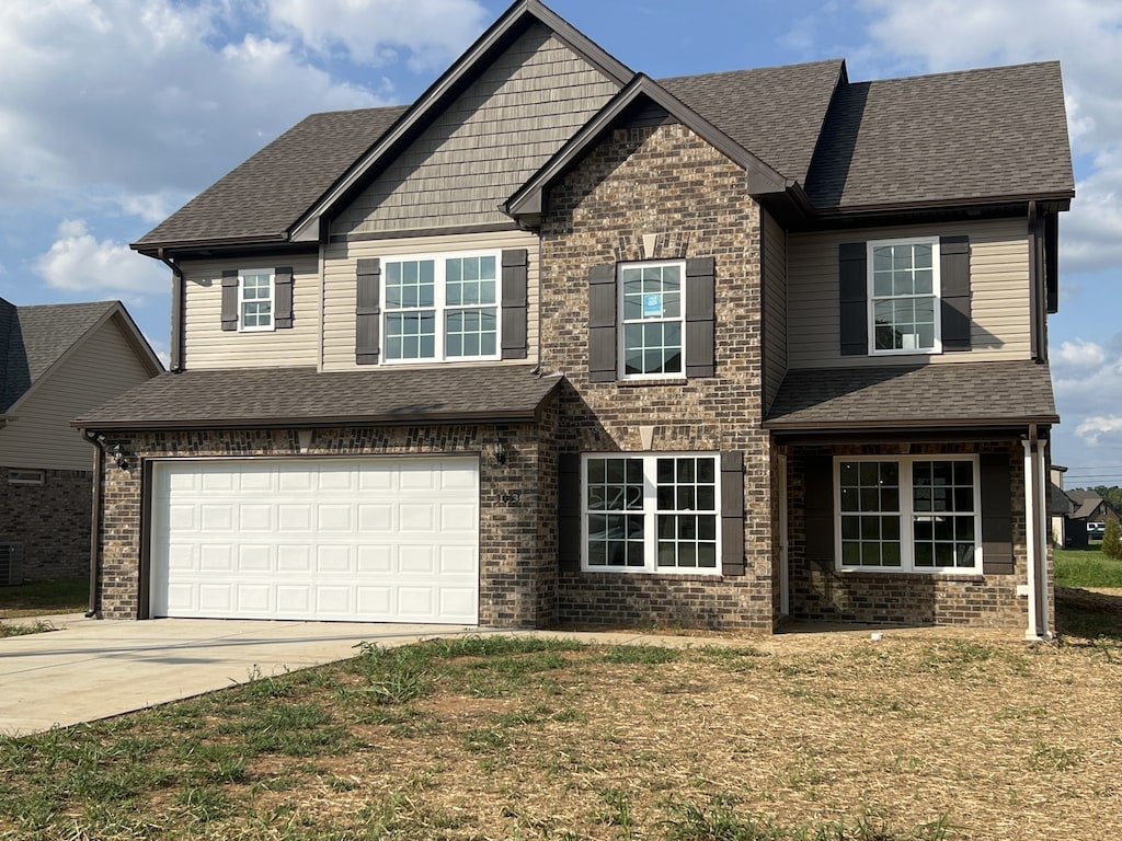 view of front facade with a garage and a front lawn