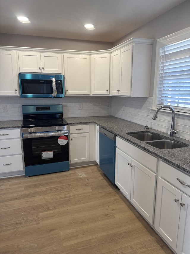 3261 Volta Rd, Christiana, TN 37037 - kitchen featuring appliances with stainless steel finishes, a sink, white cabinetry, and recessed lighting