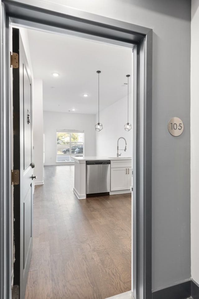 hall featuring light hardwood / wood-style flooring and sink