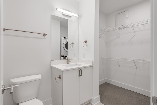 bathroom with washer / dryer, vanity, and toilet