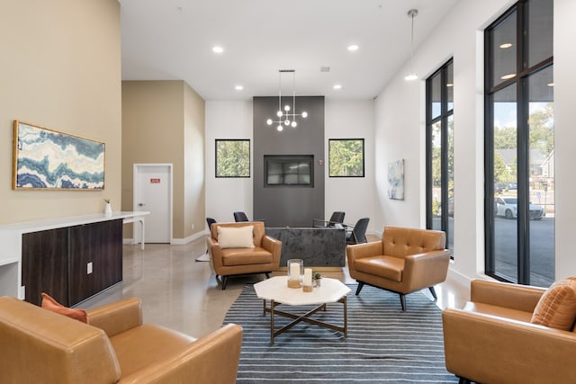 living room featuring a notable chandelier and a towering ceiling