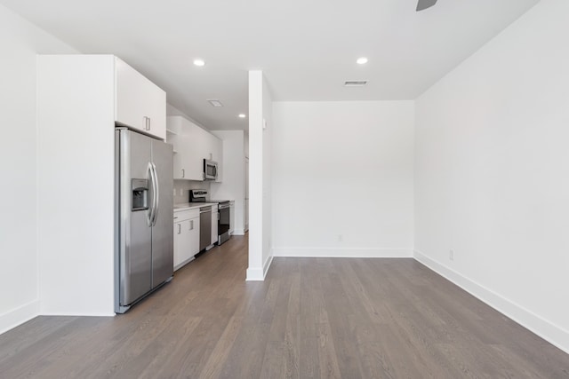 kitchen with light hardwood / wood-style flooring, white cabinetry, and appliances with stainless steel finishes