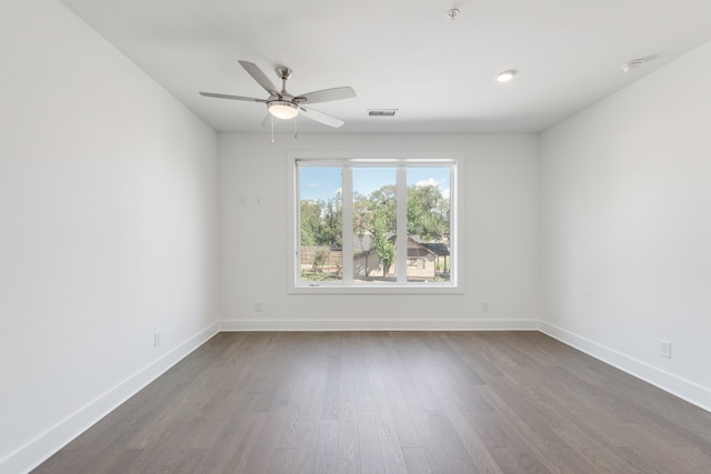 spare room with hardwood / wood-style floors and ceiling fan