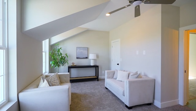 carpeted living room featuring ceiling fan and lofted ceiling