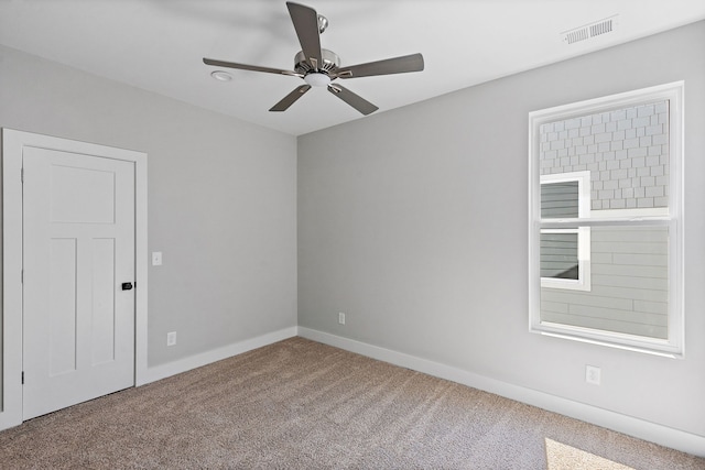 spare room featuring carpet and ceiling fan