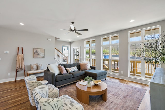 living room featuring dark hardwood / wood-style flooring and ceiling fan