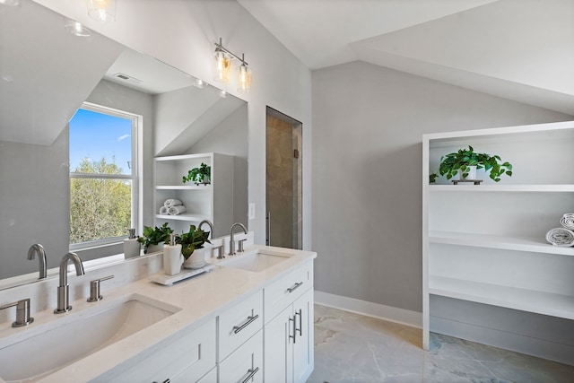 bathroom with vaulted ceiling, vanity, and tiled shower