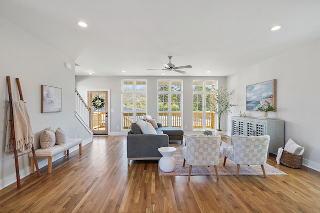 living room featuring ceiling fan and hardwood / wood-style flooring