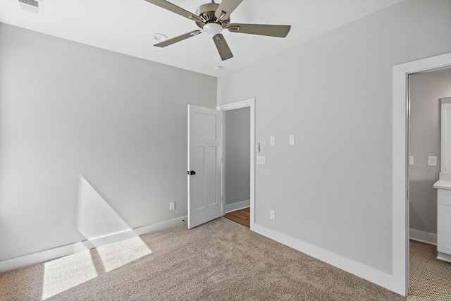 unfurnished bedroom featuring ceiling fan and light colored carpet