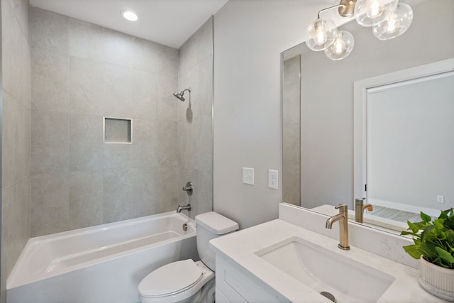 full bathroom with tiled shower / bath combo, vanity, and toilet