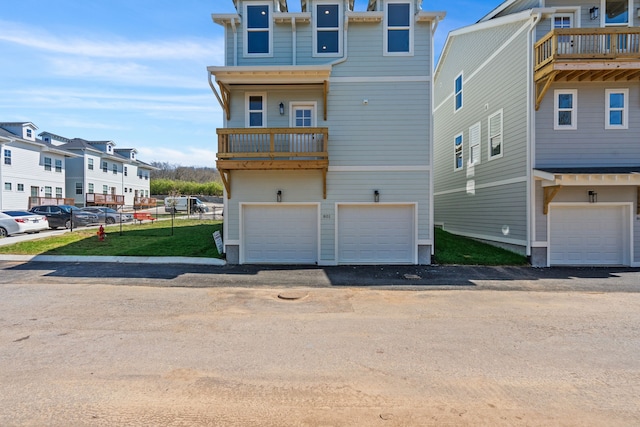 view of front of home featuring a balcony and a garage