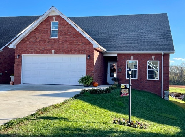 view of front of home with a garage and a front yard