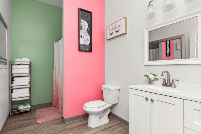 bathroom featuring hardwood / wood-style floors, vanity, and toilet