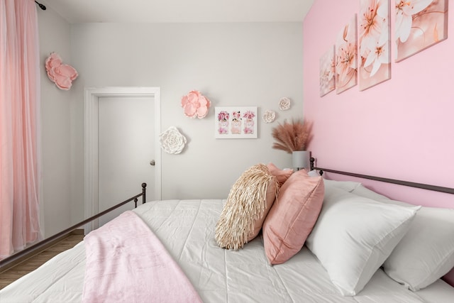 bedroom with wood-type flooring