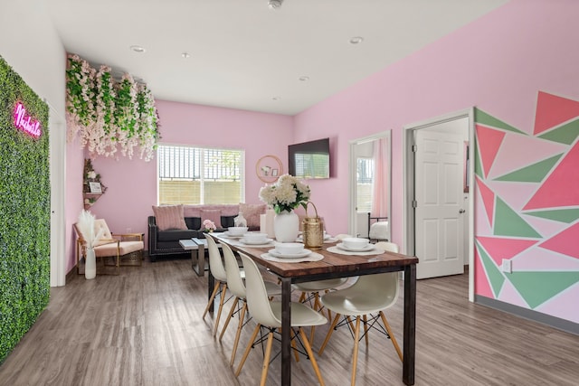 dining space with hardwood / wood-style floors