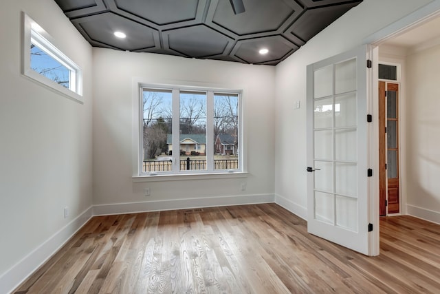 spare room featuring light hardwood / wood-style flooring and plenty of natural light