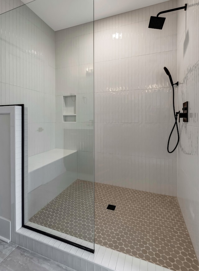 bathroom with a tile shower