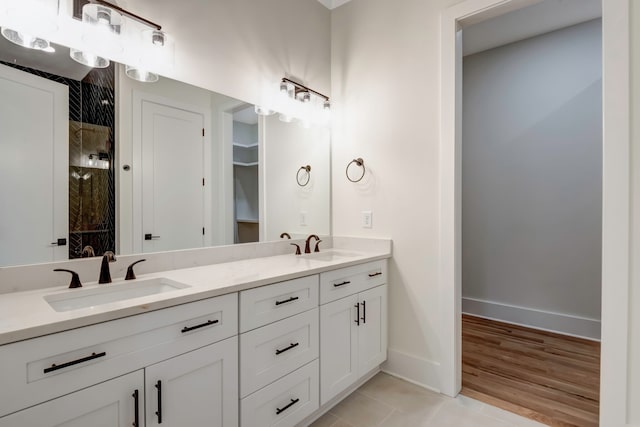 bathroom with walk in shower, hardwood / wood-style flooring, and vanity