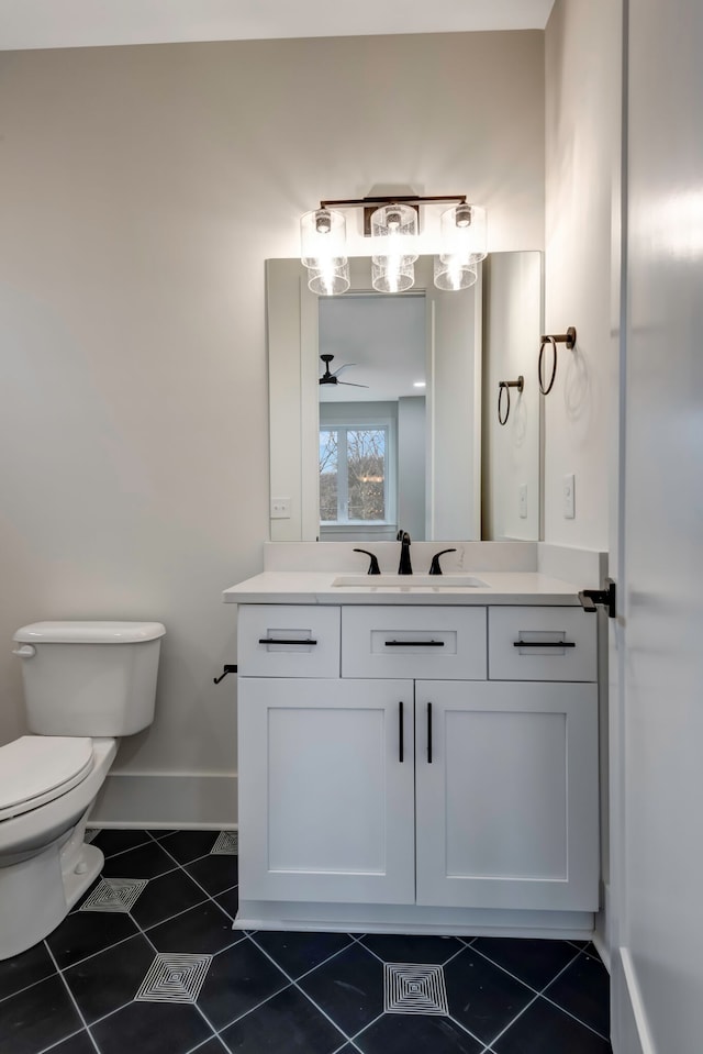 bathroom with vanity, toilet, ceiling fan, and tile patterned floors