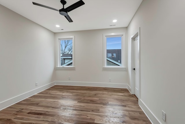 unfurnished room with ceiling fan and dark hardwood / wood-style floors