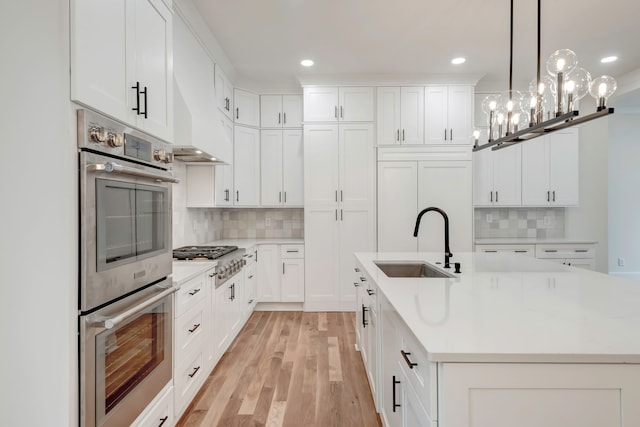 kitchen with decorative backsplash, stainless steel appliances, white cabinetry, and sink