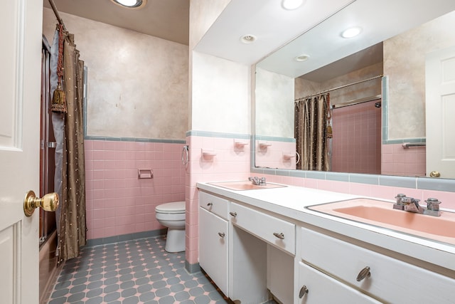 full bathroom with vanity, tile walls, shower / tub combo, and toilet