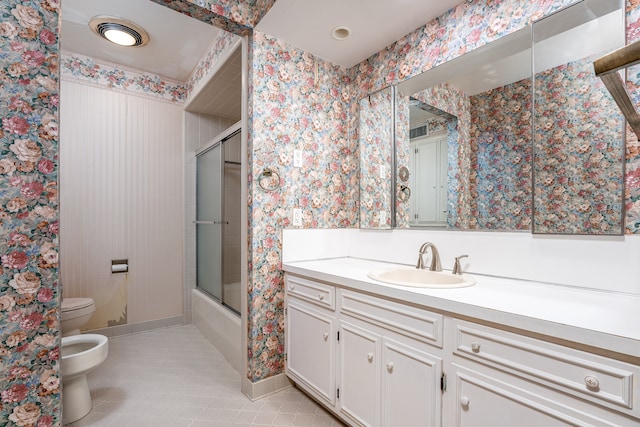 full bathroom featuring vanity, enclosed tub / shower combo, tile patterned flooring, toilet, and a bidet